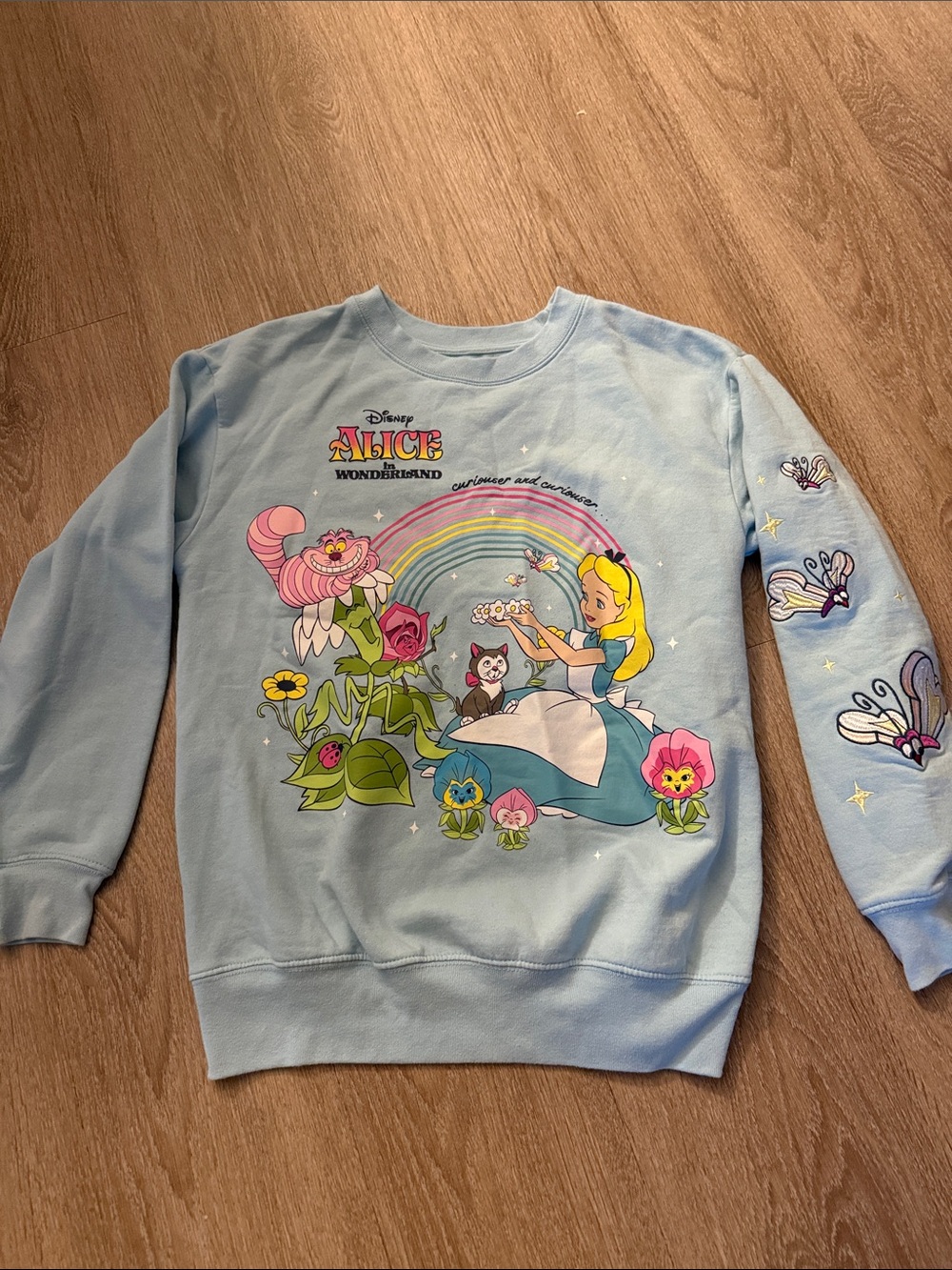 Disney Alice in Wonderland Pastel Blue Pullover with Rainbow Graphic